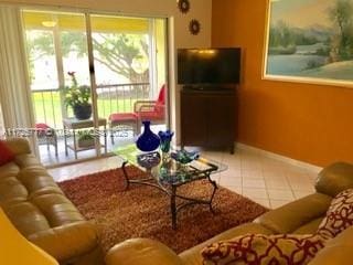 living room with tile patterned floors and a healthy amount of sunlight