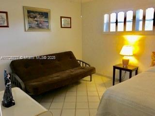 bedroom featuring light tile patterned floors