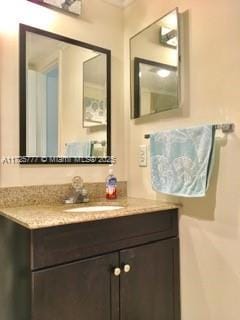 bathroom featuring vanity and ornamental molding