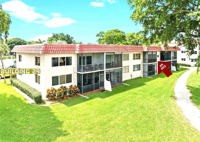 rear view of property featuring a yard