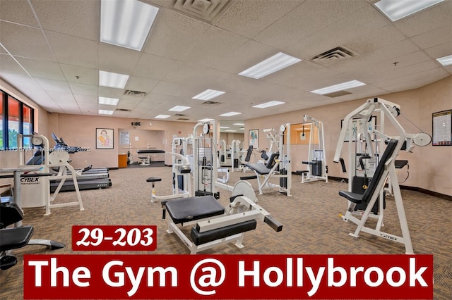 gym featuring carpet floors and a paneled ceiling