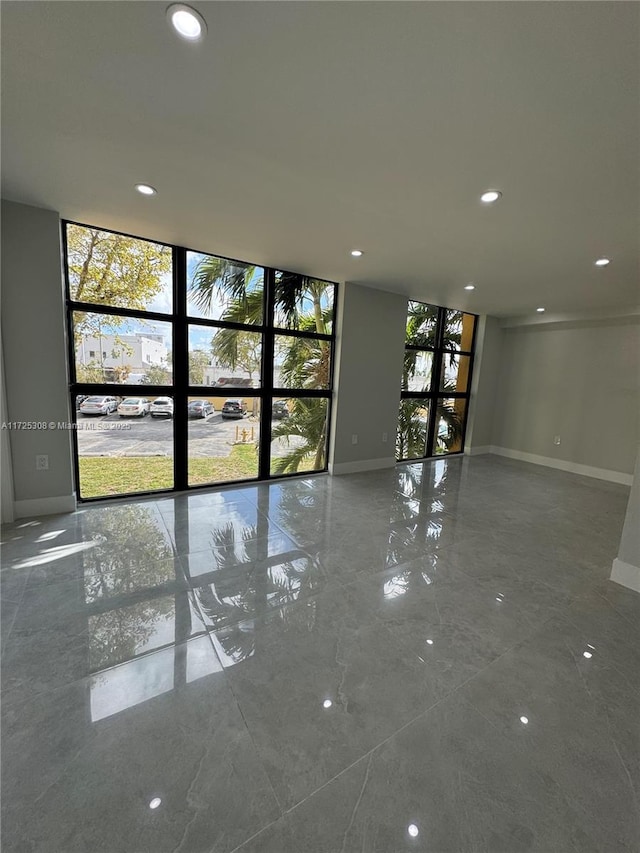 empty room featuring plenty of natural light and floor to ceiling windows