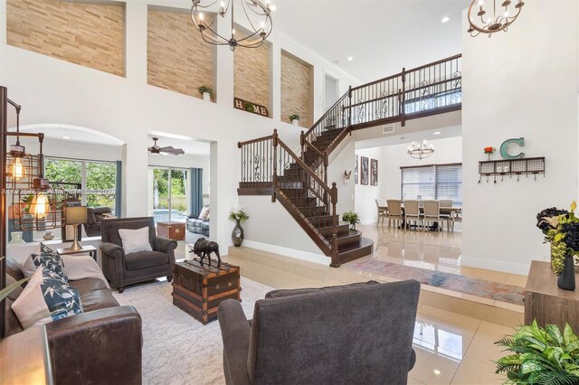 tiled living room featuring high vaulted ceiling, a notable chandelier, and crown molding