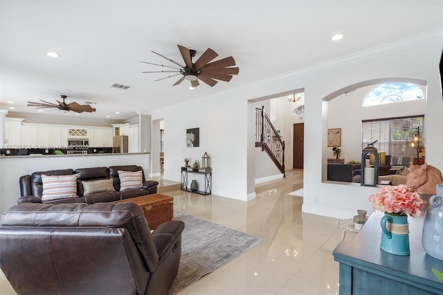 living room featuring light tile patterned floors and ornamental molding