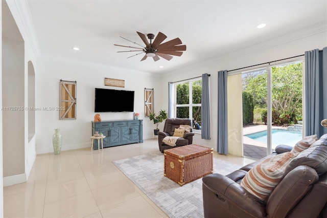 tiled living room featuring crown molding and ceiling fan