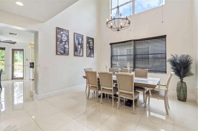 dining space featuring light tile patterned floors and a notable chandelier