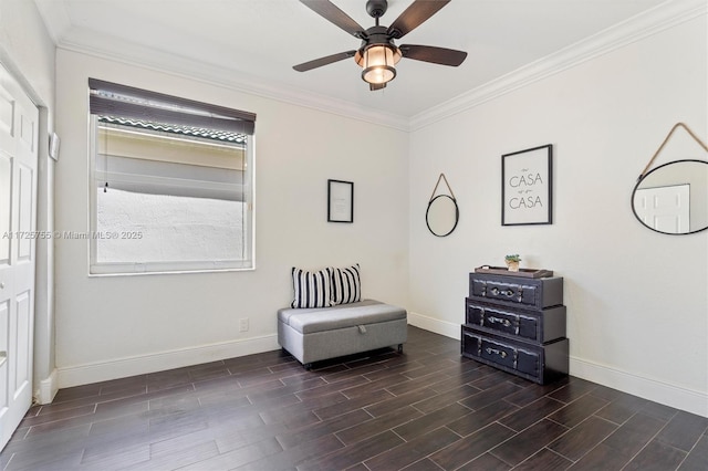 living area featuring ornamental molding and ceiling fan