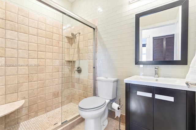 bathroom with vanity, tile walls, an enclosed shower, and toilet