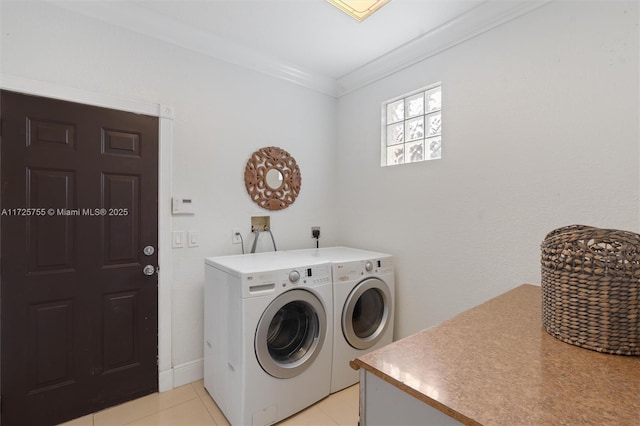 laundry area with crown molding, independent washer and dryer, and light tile patterned flooring