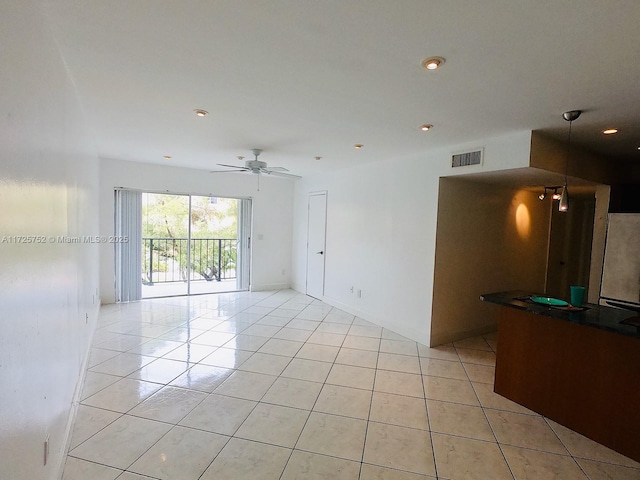 tiled empty room with ceiling fan