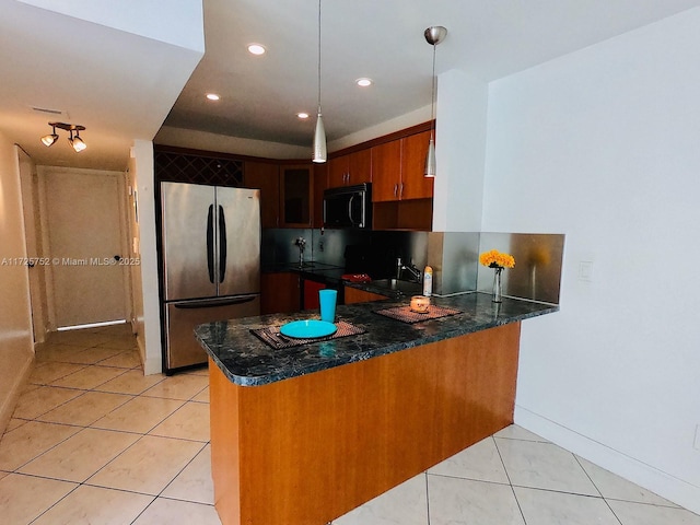 kitchen with stainless steel refrigerator, kitchen peninsula, pendant lighting, sink, and light tile patterned flooring