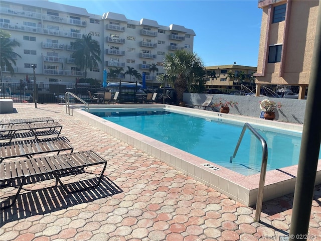 view of swimming pool with a patio