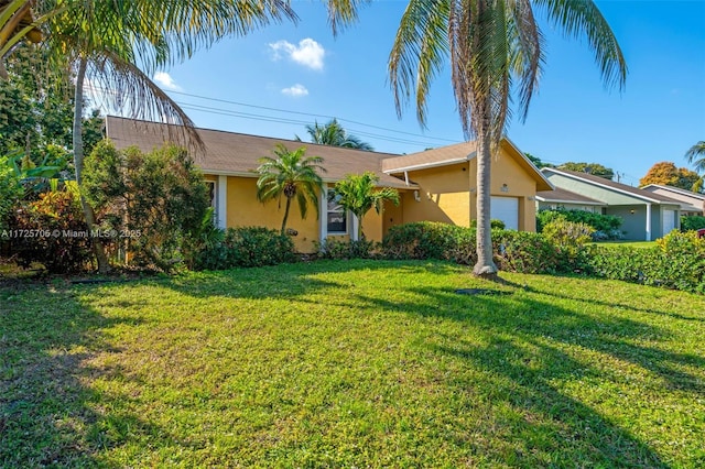 single story home featuring a front lawn and a garage