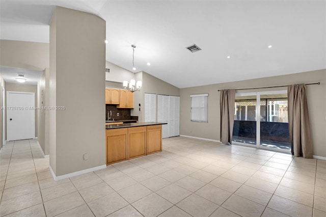 kitchen featuring vaulted ceiling, light tile patterned floors, pendant lighting, light brown cabinetry, and backsplash