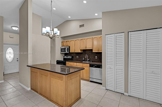 kitchen with vaulted ceiling, sink, backsplash, appliances with stainless steel finishes, and light brown cabinets