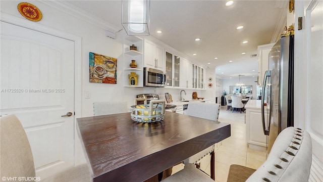 dining room with light tile patterned floors, recessed lighting, and crown molding