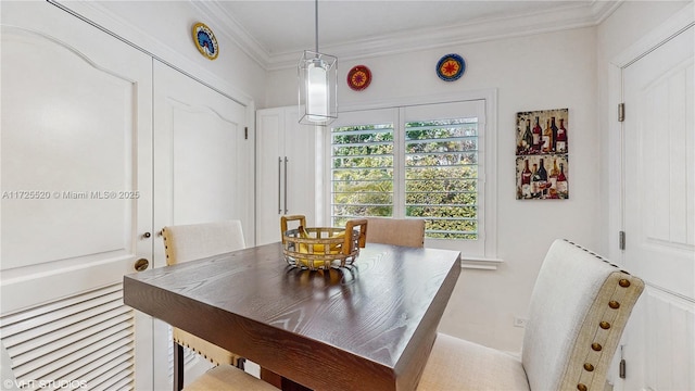 dining room featuring crown molding