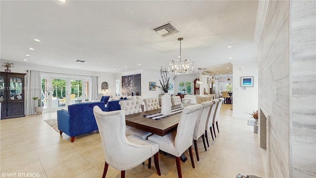 dining room with light tile patterned flooring, visible vents, french doors, and ornamental molding