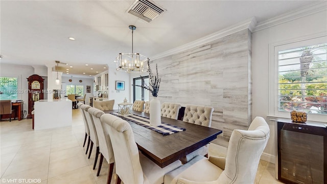 dining space with crown molding, a notable chandelier, light tile patterned floors, and visible vents