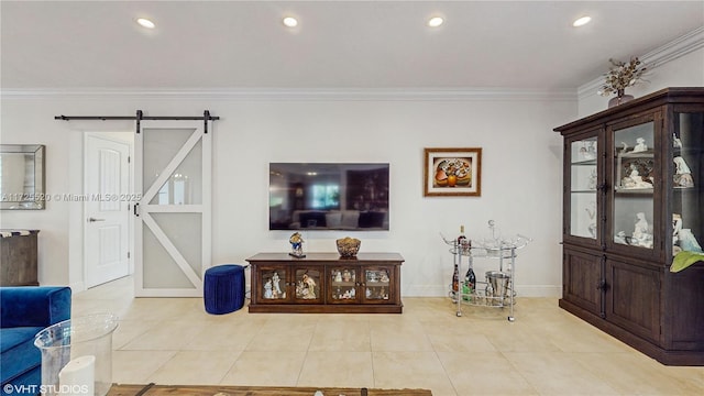 living area featuring light tile patterned floors, a barn door, ornamental molding, and recessed lighting