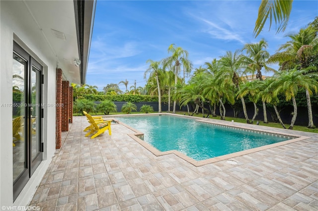 view of pool featuring a fenced backyard, a fenced in pool, and a patio