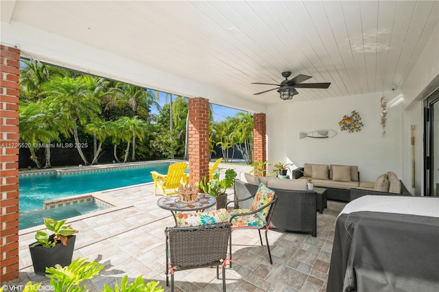 view of patio featuring an outdoor living space, an outdoor pool, an in ground hot tub, and ceiling fan