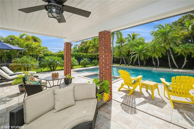 view of patio featuring an outdoor pool, outdoor lounge area, a hot tub, and a ceiling fan