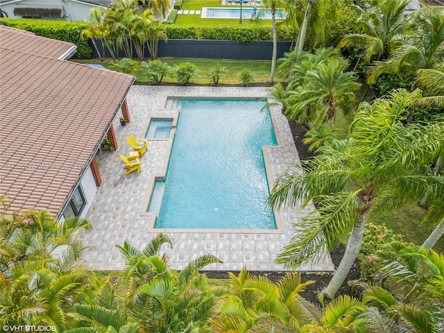 view of pool featuring a yard, a patio area, and a fenced in pool