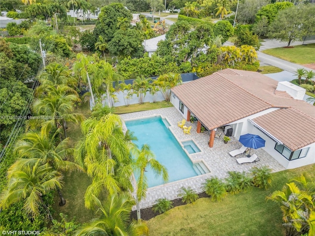 view of swimming pool featuring a pool with connected hot tub, a fenced backyard, and a patio area