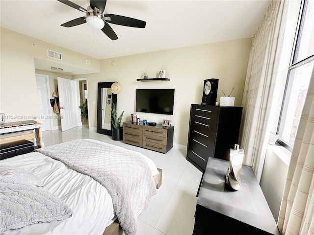 bedroom featuring light tile patterned floors, ceiling fan, and visible vents