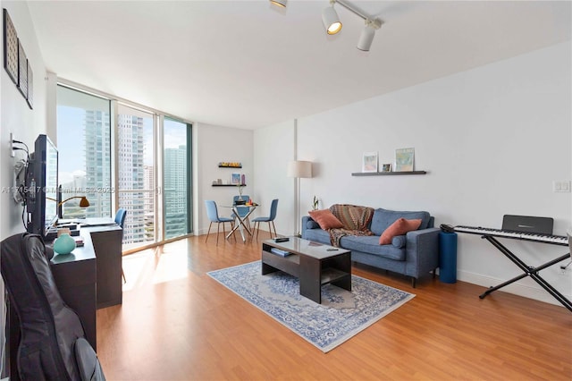 living room featuring wood-type flooring and floor to ceiling windows