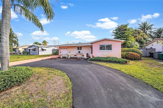 view of front of house with a front lawn and a garage