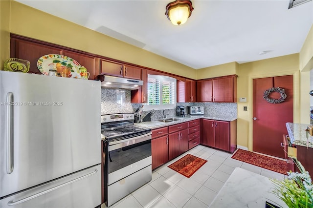 kitchen featuring sink, light tile patterned floors, backsplash, and appliances with stainless steel finishes