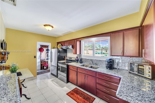 kitchen featuring sink, light tile patterned flooring, backsplash, and electric stove