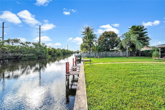 dock area with a yard and a water view