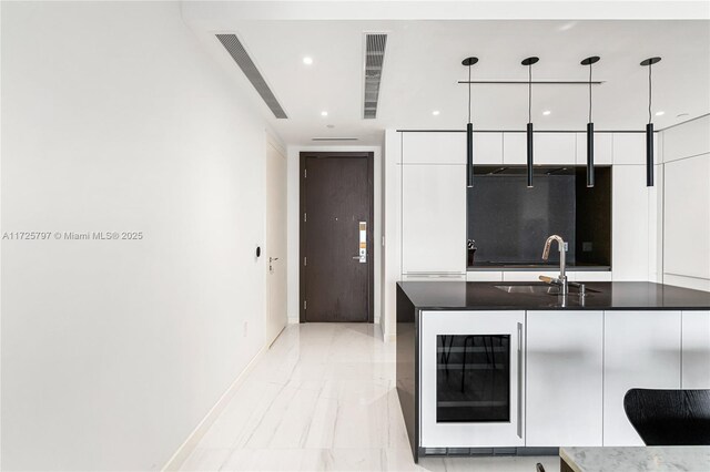 300 Biscayne Blvd Way Unit 2505, Miami, FL 33131 - kitchen featuring beverage cooler, a sink, modern cabinets, white cabinetry, and baseboards