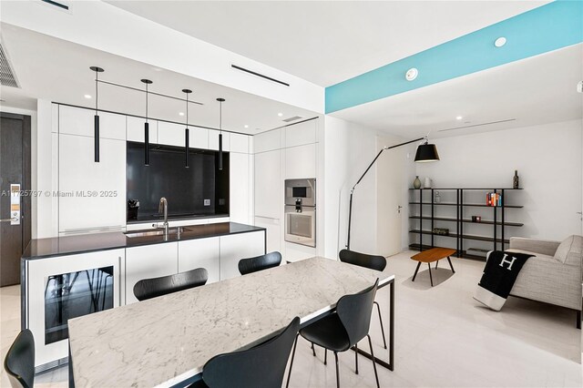 300 Biscayne Blvd Way Unit 2505, Miami, FL 33131 - kitchen featuring modern cabinets, a sink, beverage cooler, white cabinets, and a breakfast bar