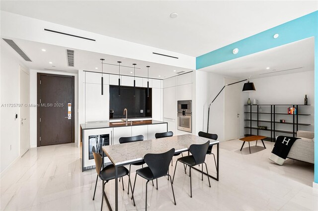 300 Biscayne Blvd Way Unit 2505, Miami, FL 33131 - dining space with beverage cooler, recessed lighting, light marble finish flooring, and bar