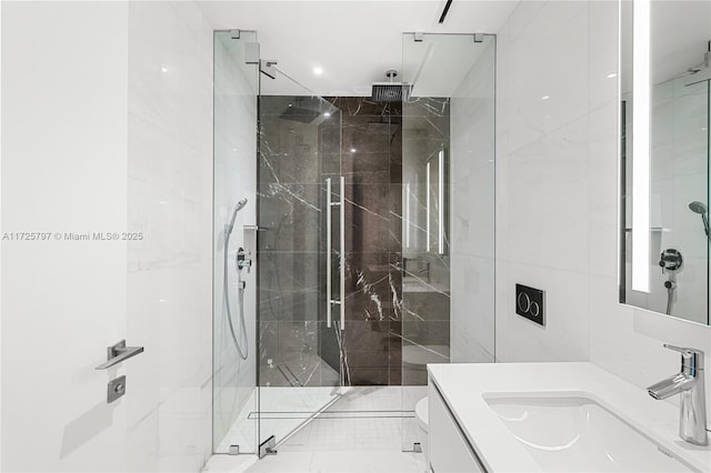 bathroom featuring toilet, a shower with door, and vanity