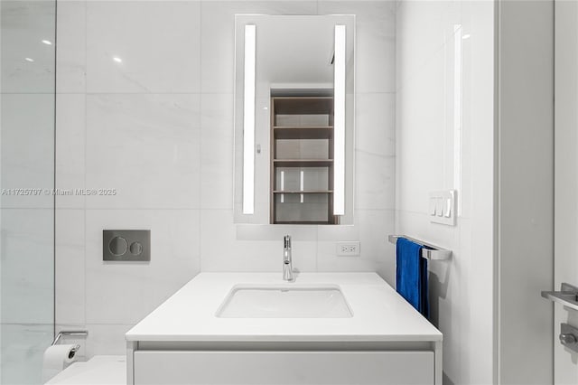 bathroom with tile walls and vanity