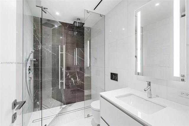 300 Biscayne Blvd Way Unit 2505, Miami, FL 33131 - bathroom featuring vanity, a marble finish shower, toilet, recessed lighting, and tile walls