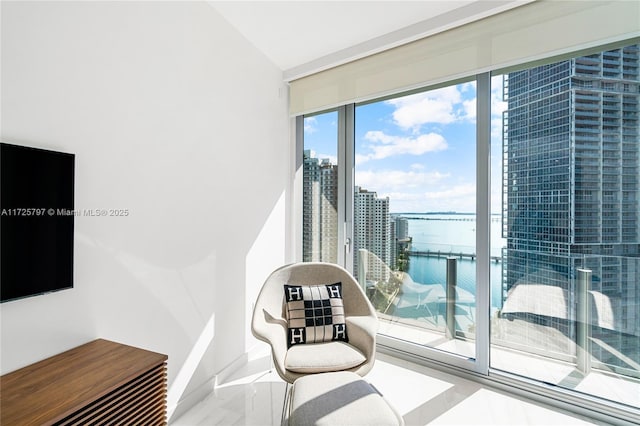 living area featuring floor to ceiling windows and a water view