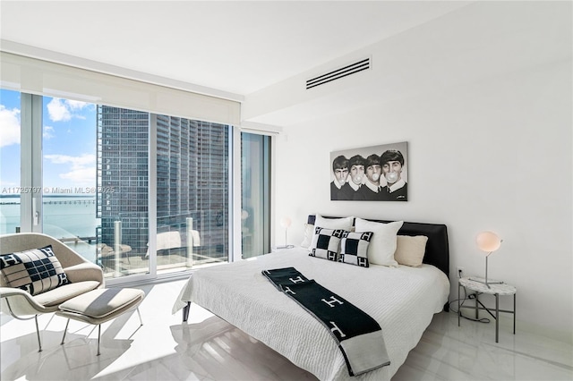 bedroom featuring expansive windows and multiple windows