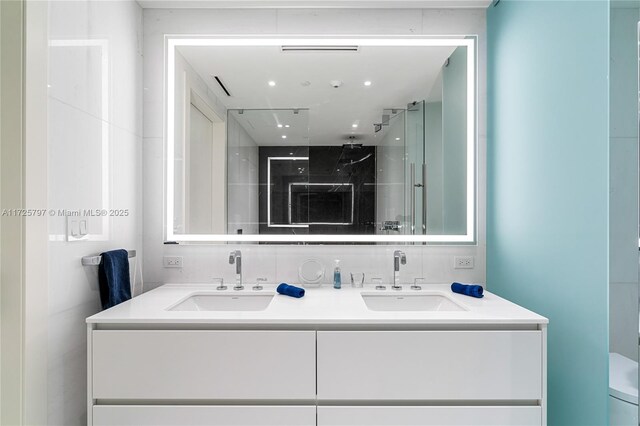 300 Biscayne Blvd Way Unit 2505, Miami, FL 33131 - bathroom featuring double vanity, walk in shower, and toilet
