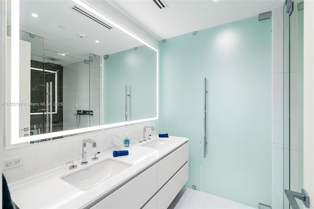 bathroom featuring an enclosed shower, tile patterned floors, and vanity