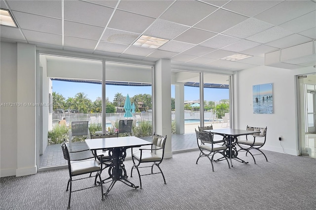 9381 E Bay Harbor Dr Unit 401N, Bay Harbor Islands, FL 33154 - dining room featuring carpet flooring, baseboards, a drop ceiling, and expansive windows