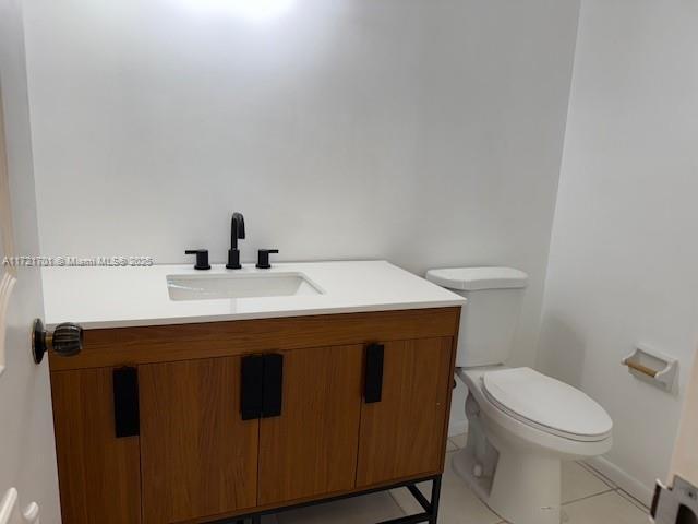 9381 E Bay Harbor Dr Unit 401N, Bay Harbor Islands, FL 33154 - bathroom featuring toilet, tile patterned floors, and vanity