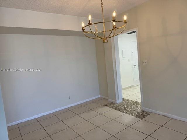 9381 E Bay Harbor Dr Unit 401N, Bay Harbor Islands, FL 33154 - unfurnished room featuring a chandelier, light tile patterned floors, a textured ceiling, and baseboards