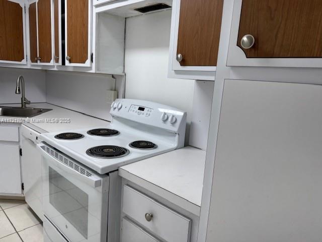9381 E Bay Harbor Dr Unit 401N, Bay Harbor Islands, FL 33154 - kitchen with white appliances, a sink, light countertops, light tile patterned flooring, and white cabinets
