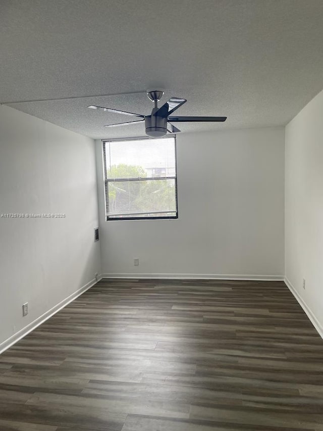 unfurnished room featuring a textured ceiling, ceiling fan, and dark hardwood / wood-style floors